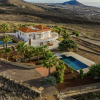 Luxury Villa for Sale in San Miguel de Abona, Tenerife.Features include a heated pool, sauna, landscaped gardens, and breathtaking views.